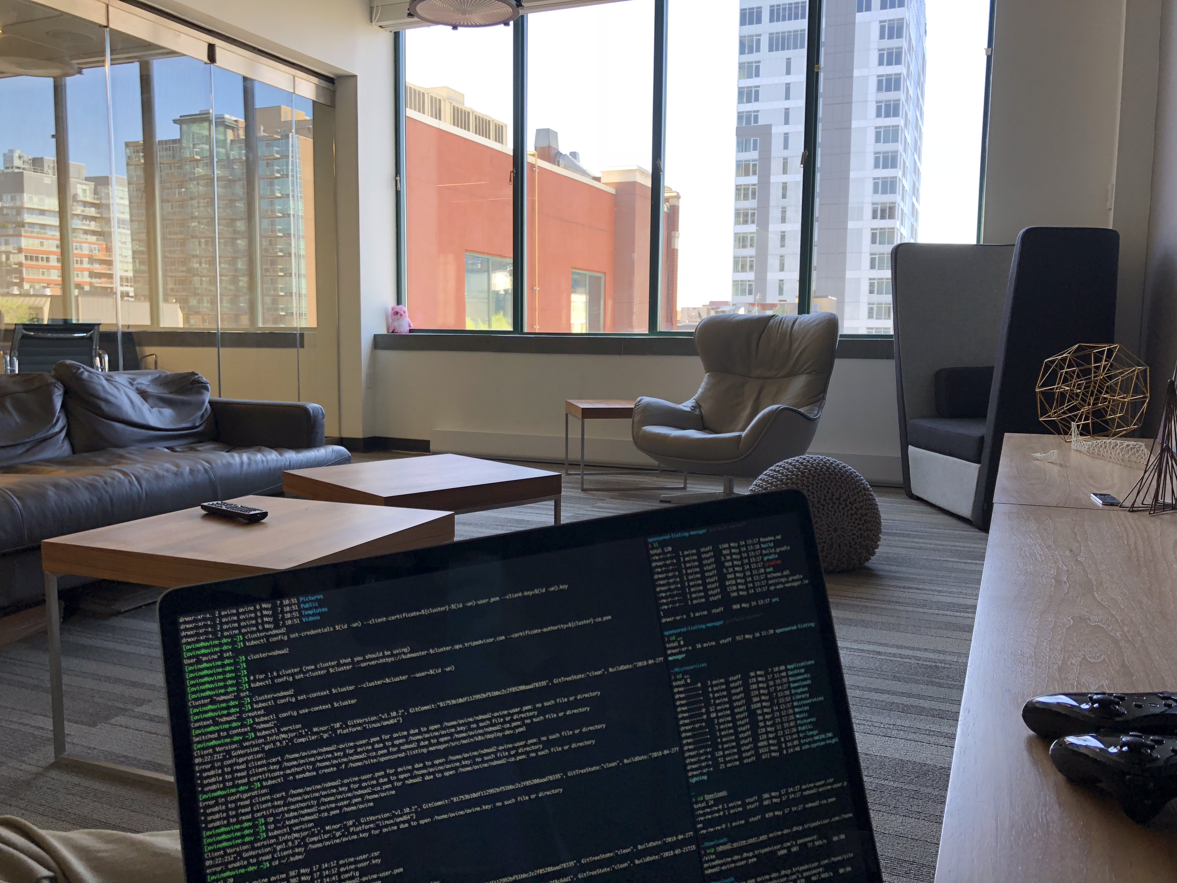 A POV shot of the lounge area of the TripAdivsor Canada building, looking over a laptop displaying code